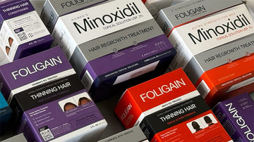 Kutularda çeşitli FOLIGAIN minoksidil ve TRIOXIDIL saç bakım ürünleri.